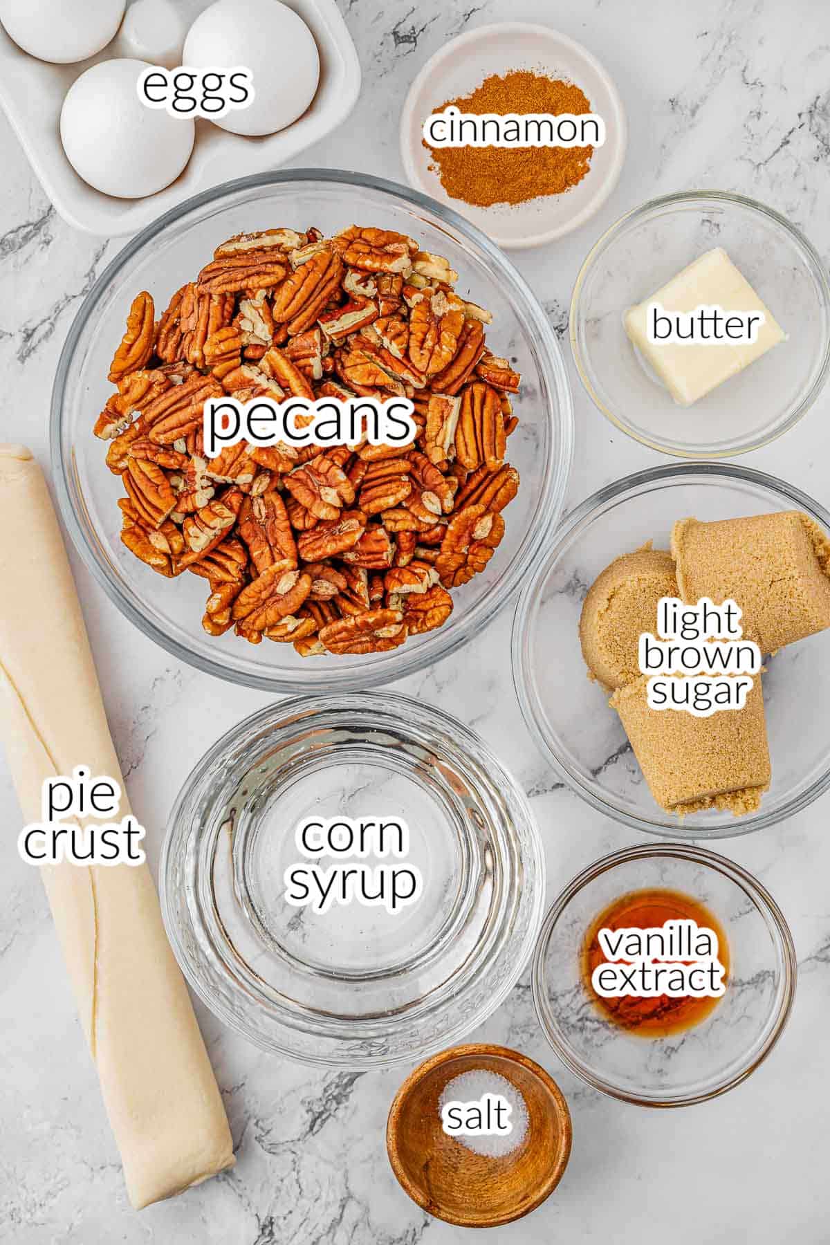 ingredients for pecan pie - pecans, eggs, cinnamon, butter, light brown sugar, pie crust, corn syrup, salt and vanilla extract.