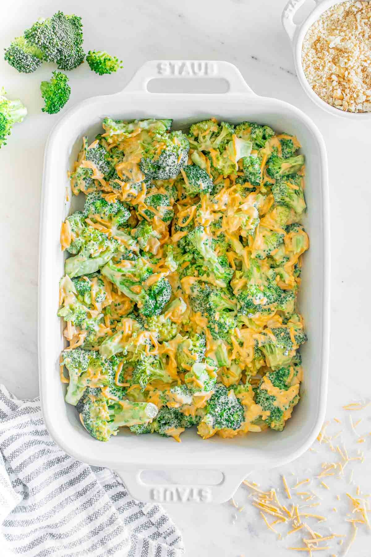 Broccoli and cheese casserole in a white baking dish.