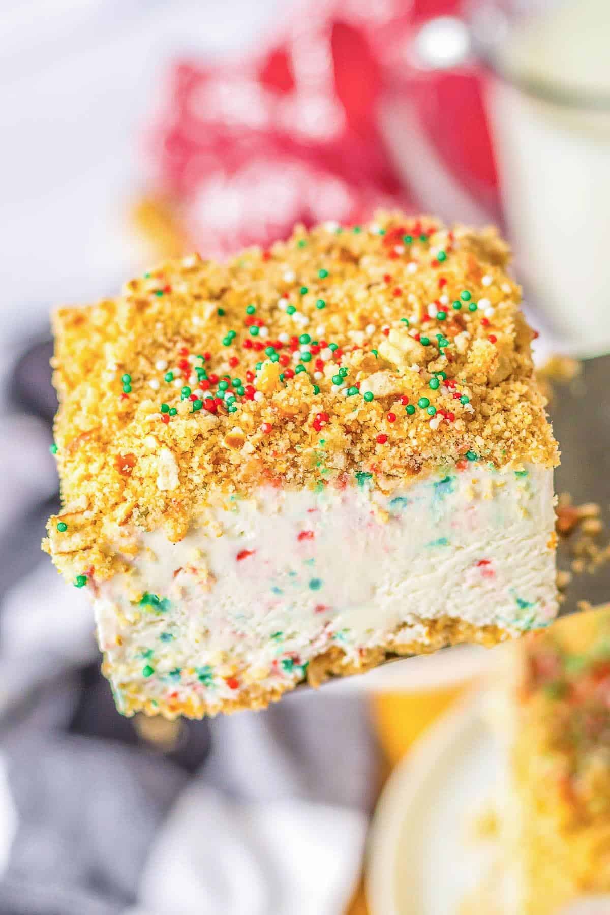 A piece of Christmas Crunch Cake being held up by a spatula.