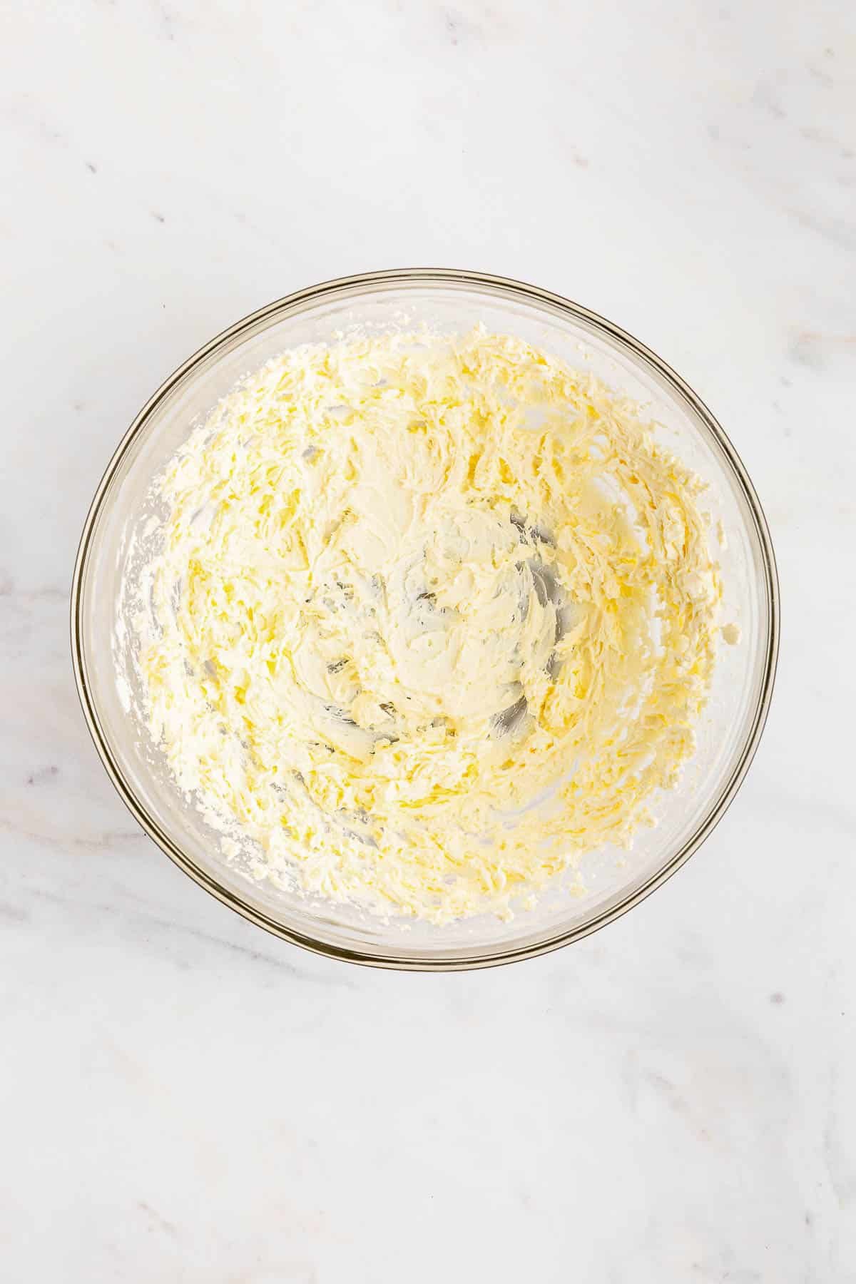 a glass bowl with whipped cream cheese.