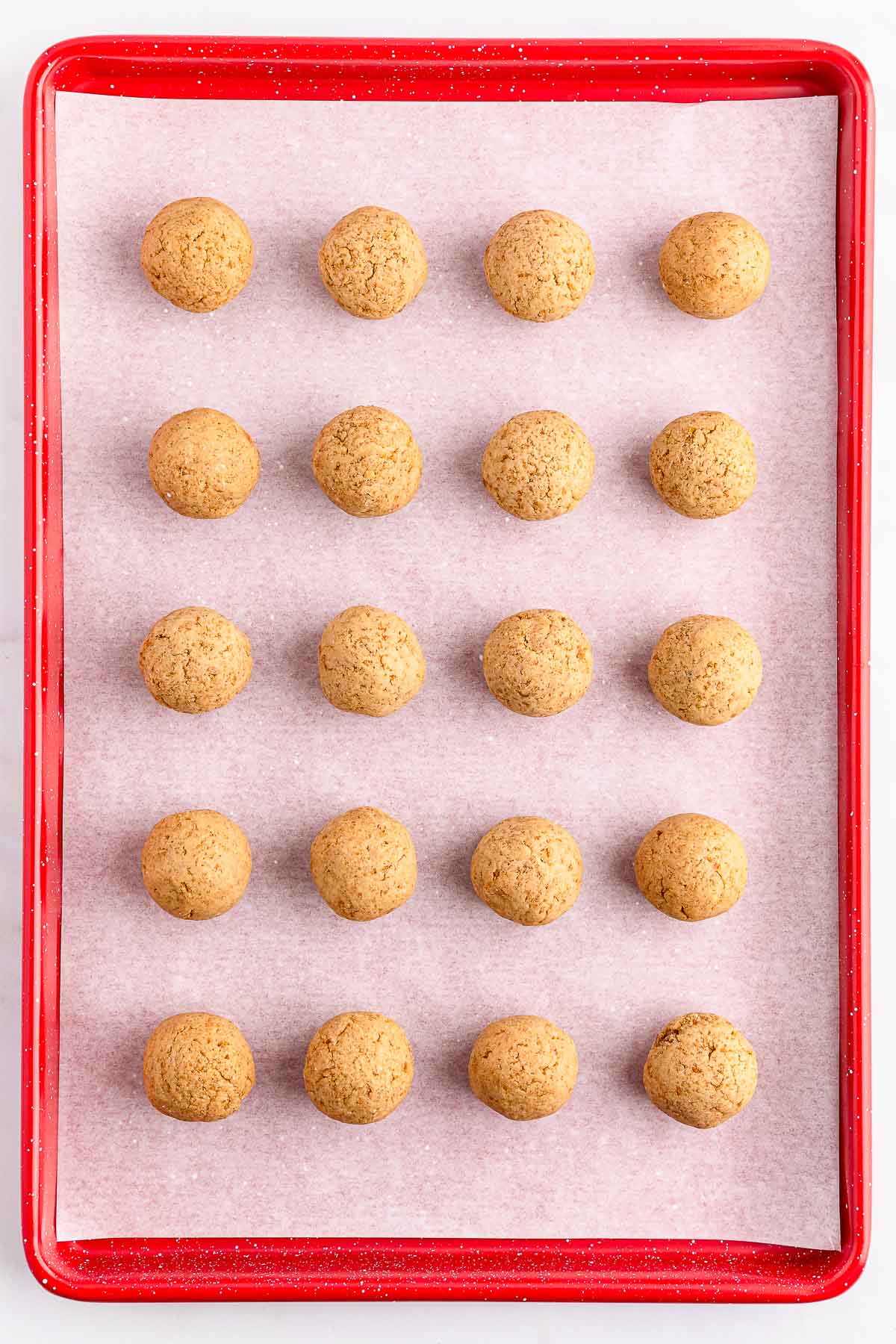 A tray of gingerbread truffle balls lined up.