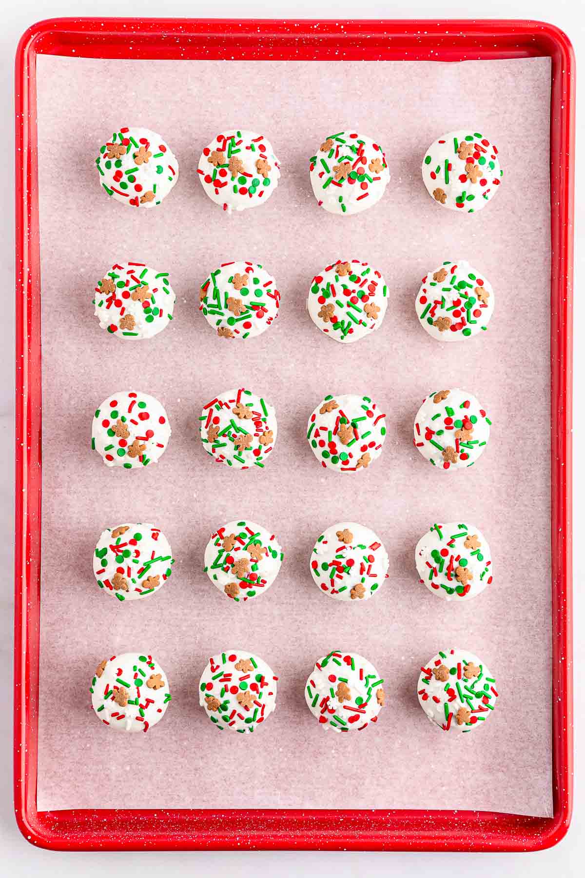A red tray of Gingerbread truffles topped with sprinkles.