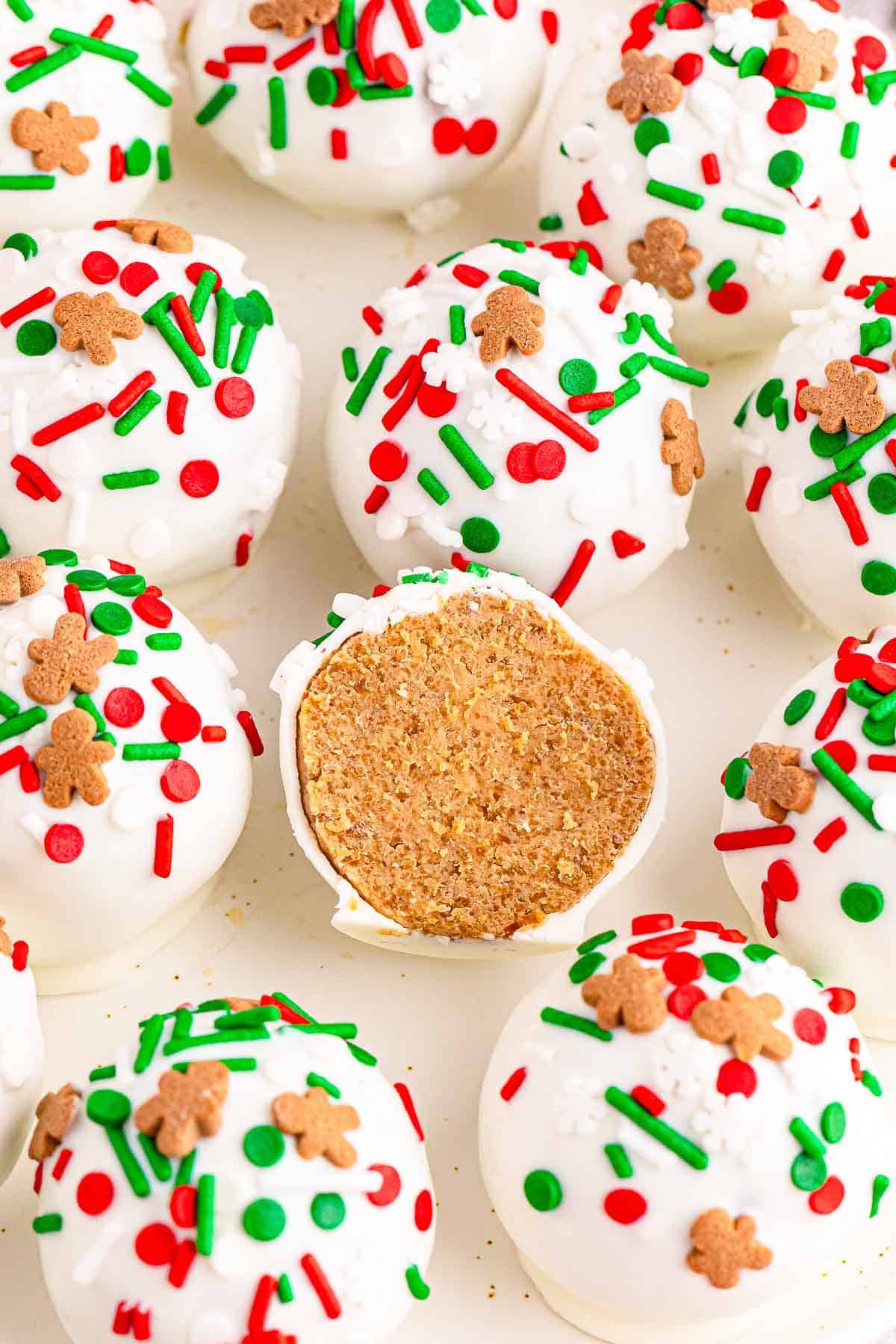 Several gingerbread truffles with sprinkles on a white plate.
