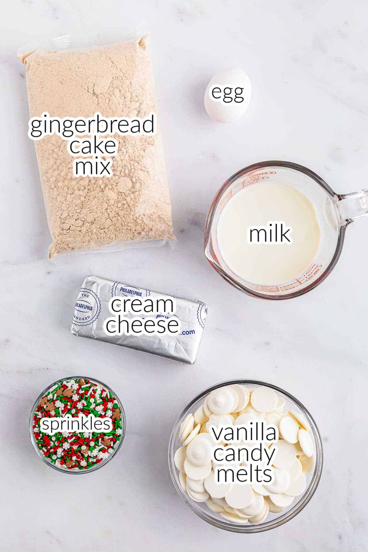 Ingredients for gingerbread truffles - eggs, milk, gingerbread cake mix, cream cheese, sprinkles and vanilla candy melts.