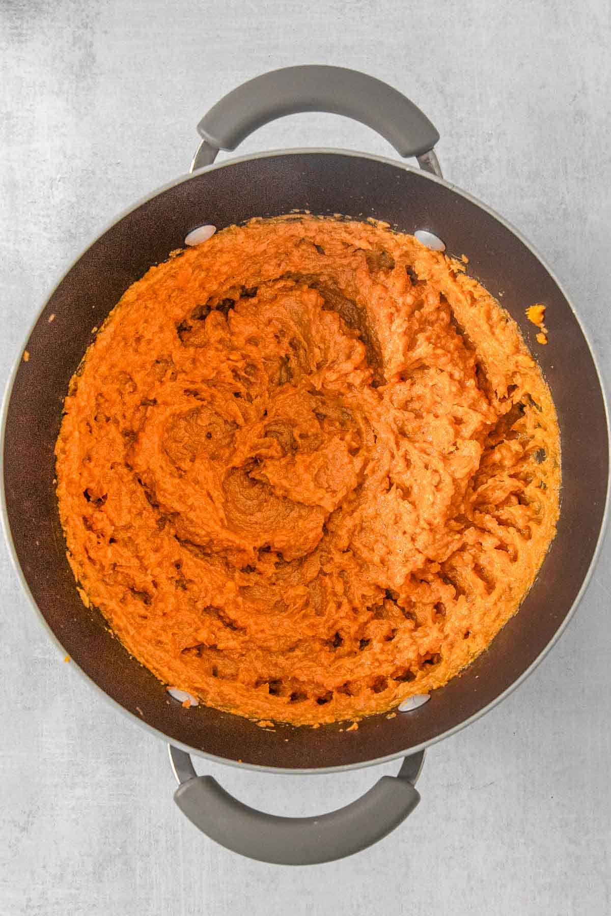 Mashed sweet potatoes in a large cooking pot.