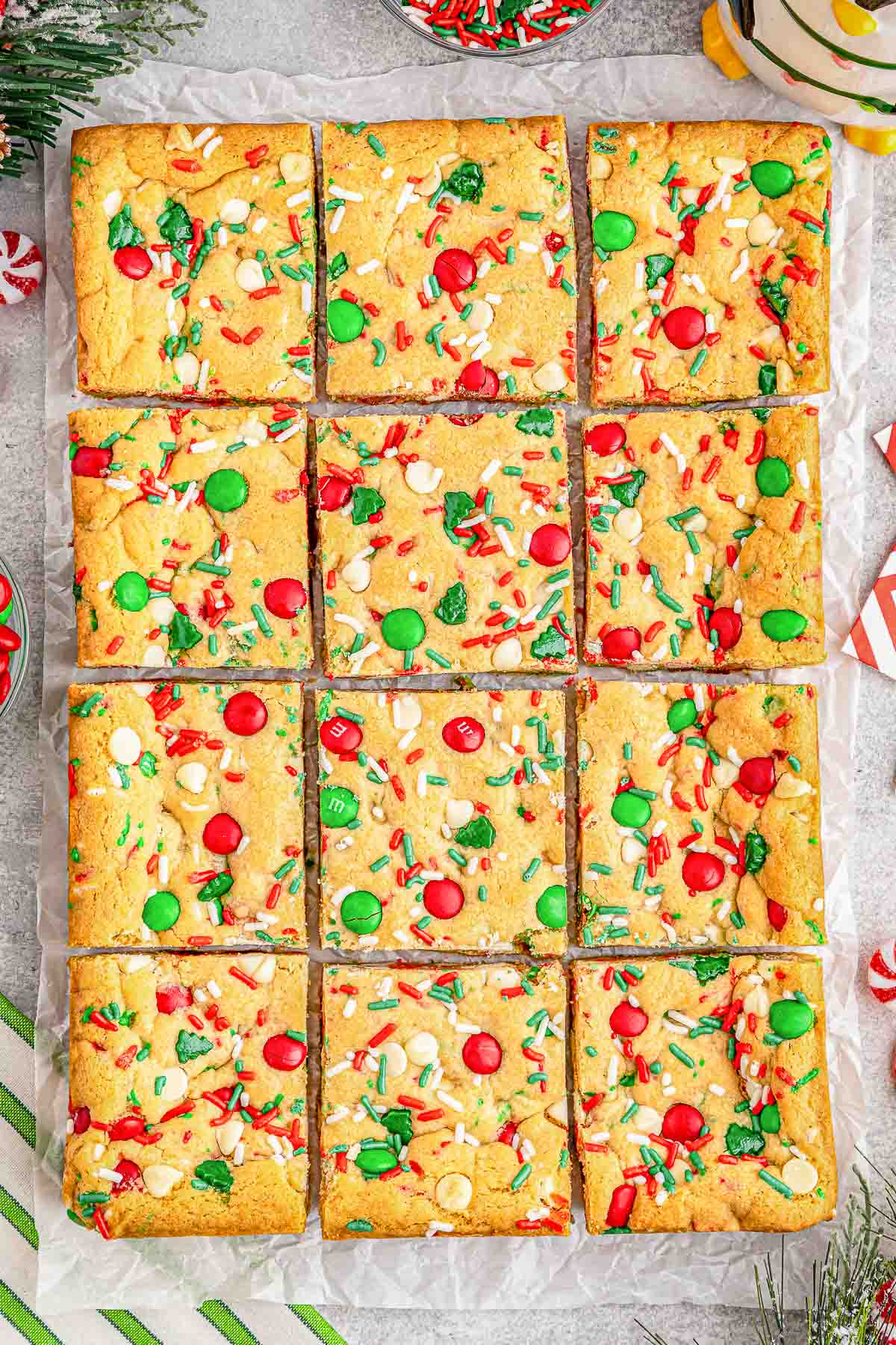 Multiple M&M cookie bars on a baking sheet.
