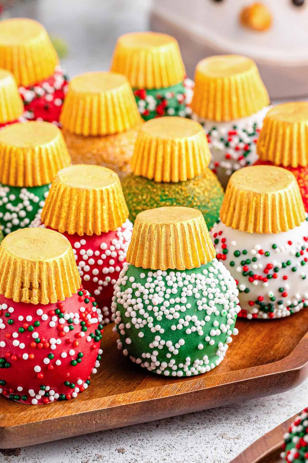 A tray of Christmas oreo balls with different colored holiday sprinkles.