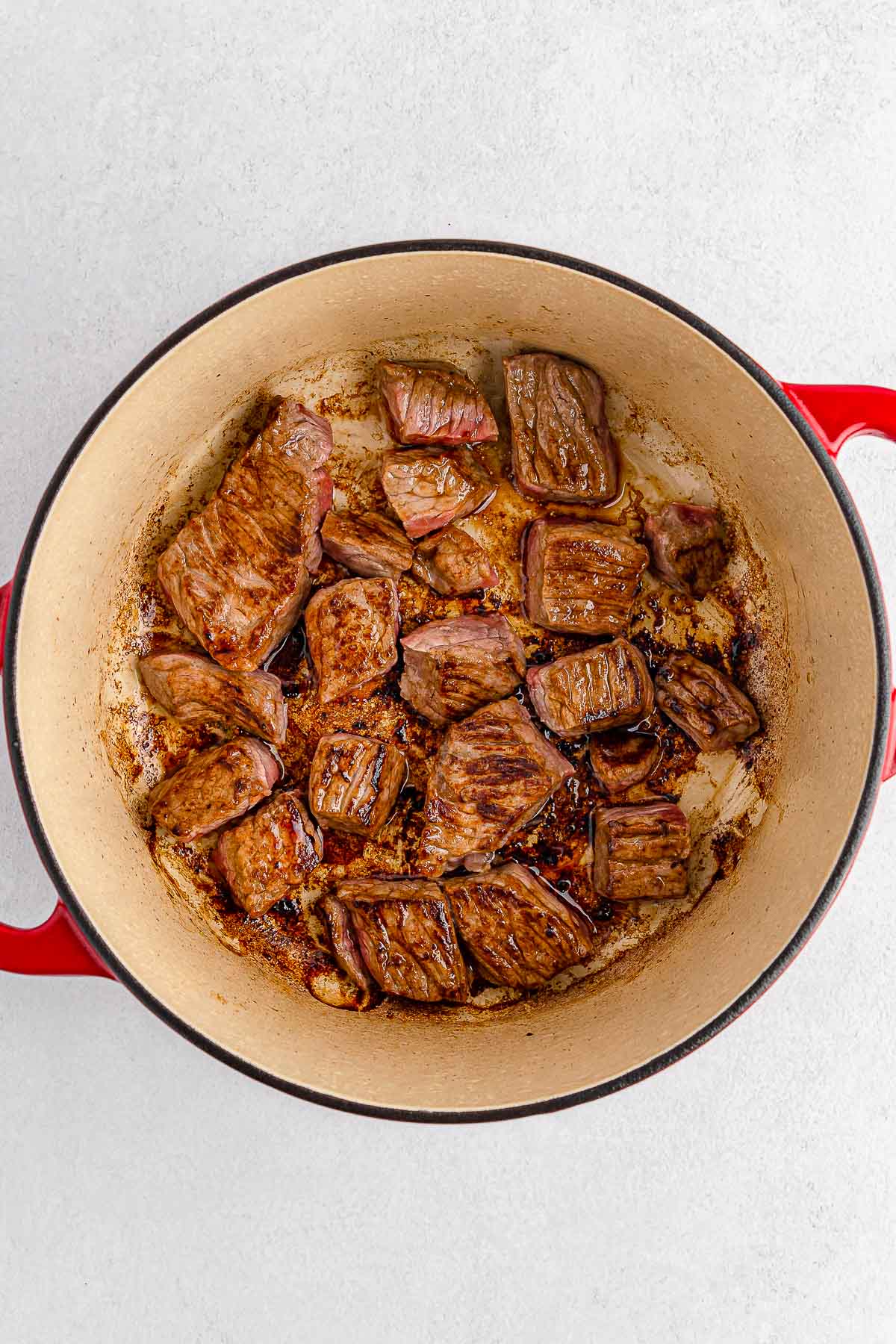 A pot with meat in it on a white background.