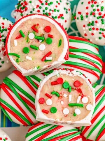 Several sugar cookie truffles stacked on a holiday plate.
