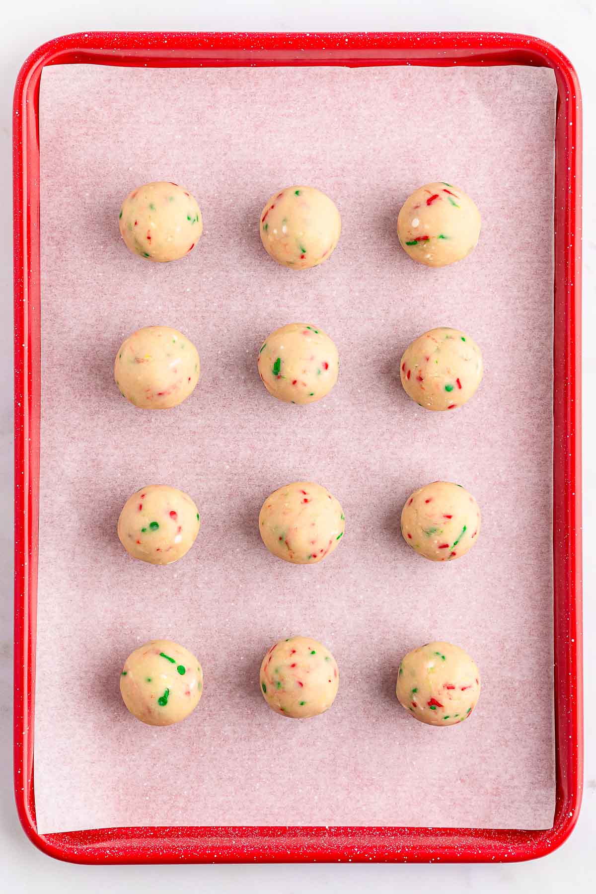 A tray lined with sugar cookie dough balls.