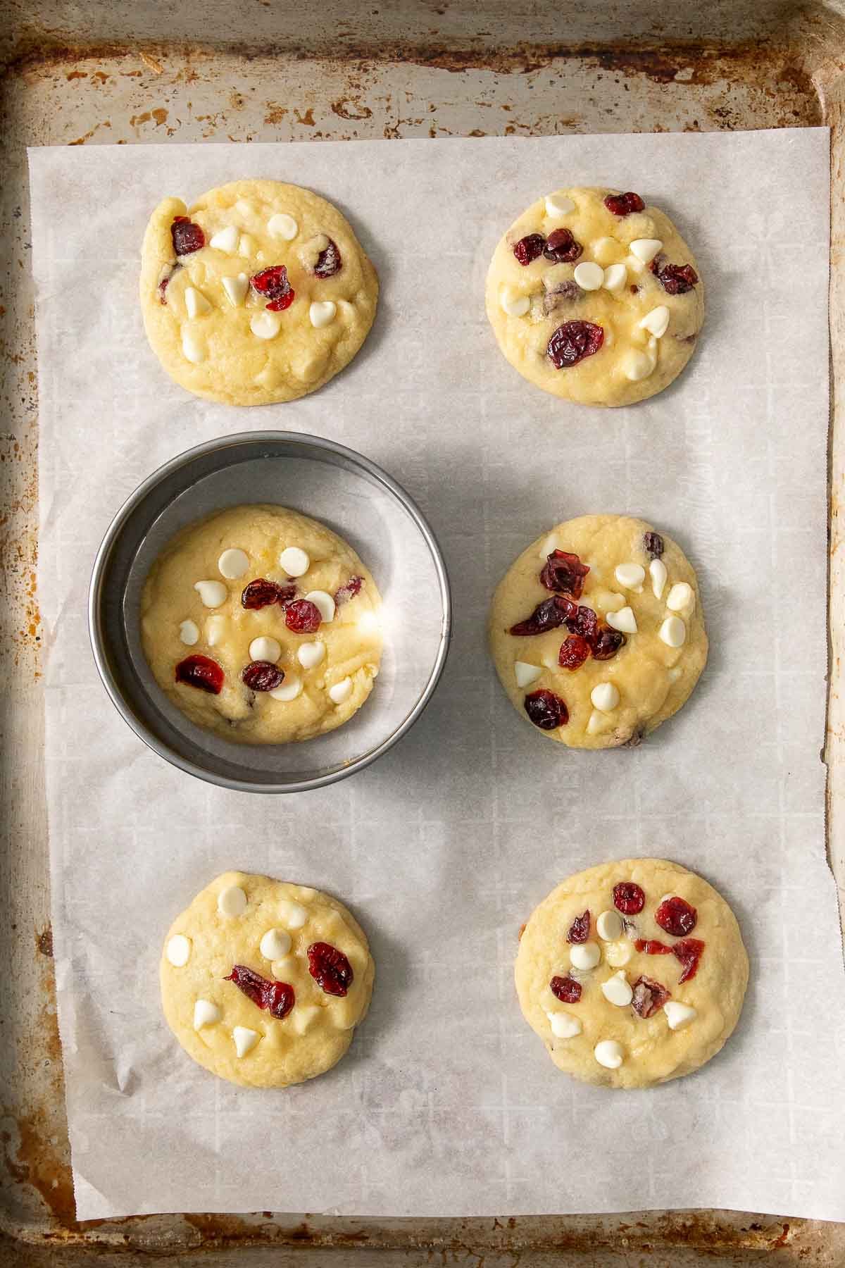 White chocolate cranberry cookie dough on a baking sheet.