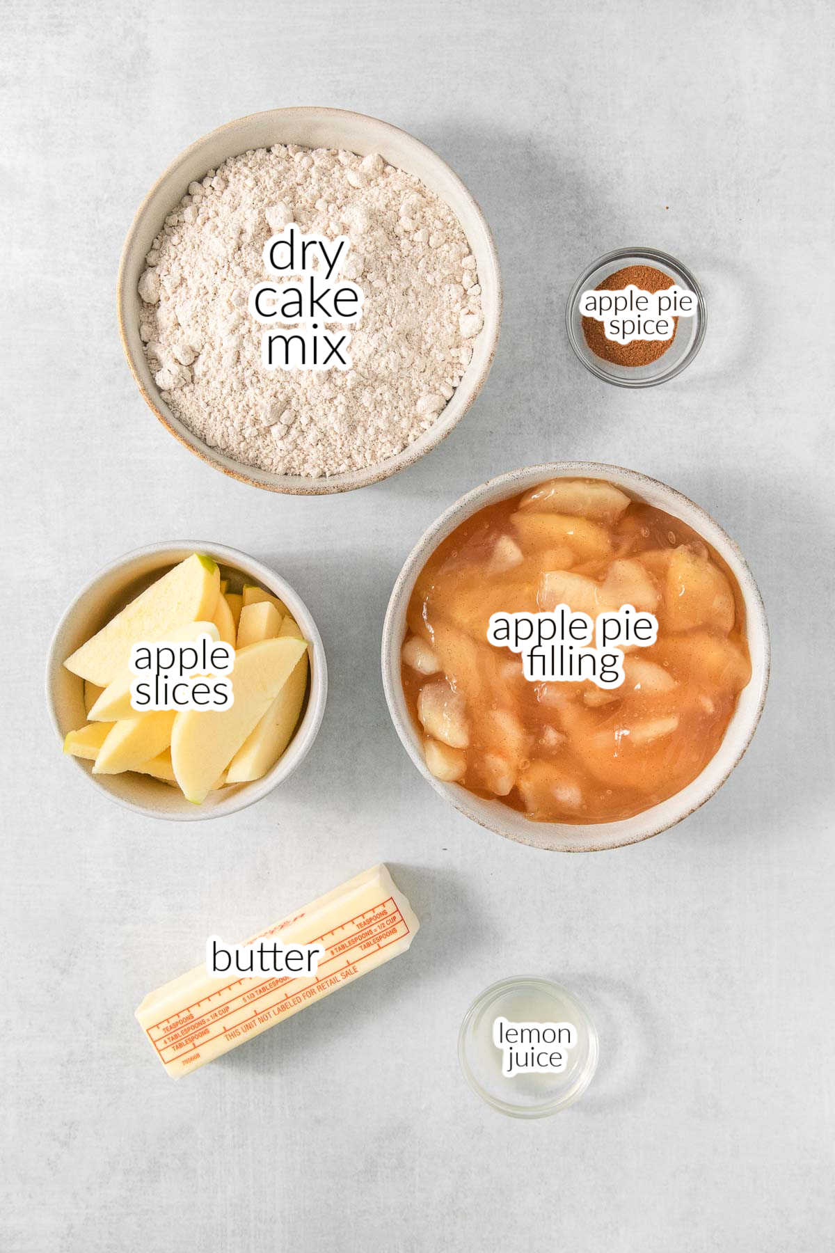 Dry apple pie ingredients in a bowl on a white background.