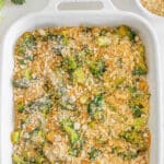 Easy broccoli casserole with buttery ritz cracker crumb topping in a white casserole dish.
