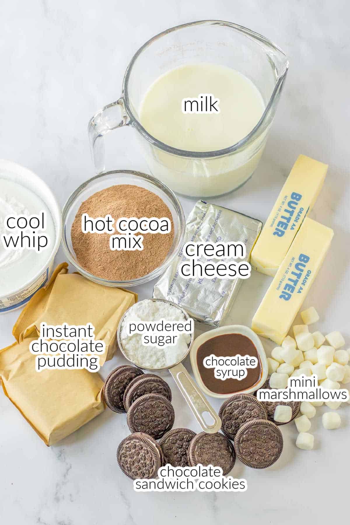 ingredients for chocolate oreo delight - cool whip, hot cocoa mix, milk, pudding powdered sugar, oreos and cream cheese, and butter.
