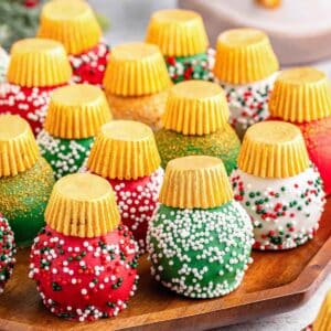 A tray of Christmas oreo balls with different colored holiday sprinkles.