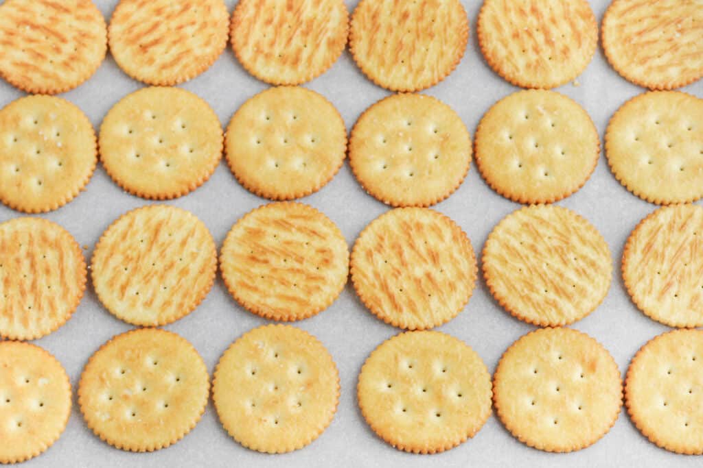 Ritz crackers on a baking sheet.