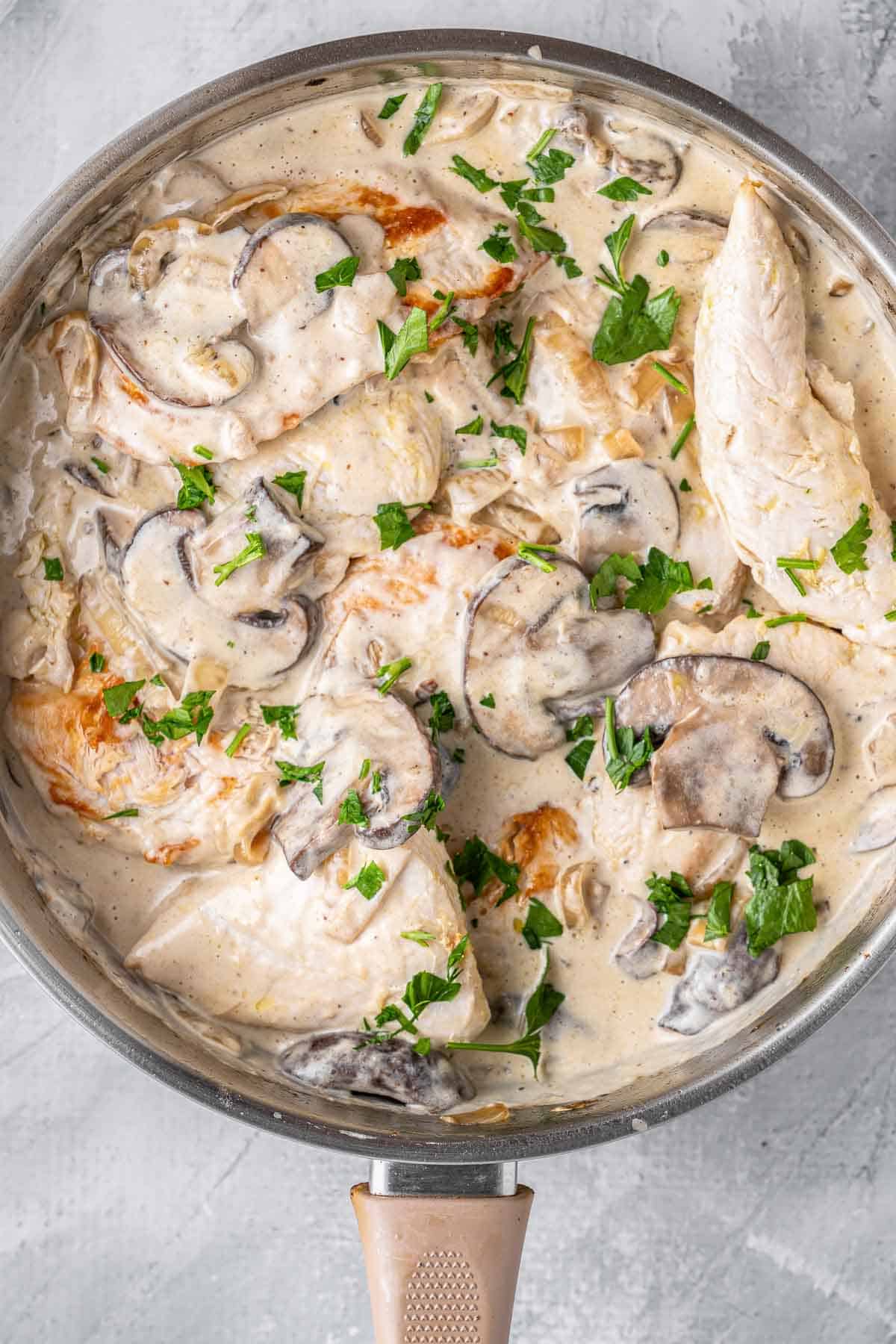 Chicken with mushrooms cream sauce in a skillet.