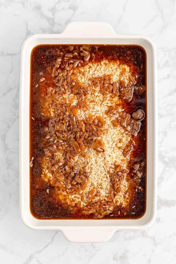 A casserole dish with onion soup on top on rice.