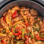 Air fryer chicken fajitas in a the air fryer basket with the text air fryer chicken fajitas.