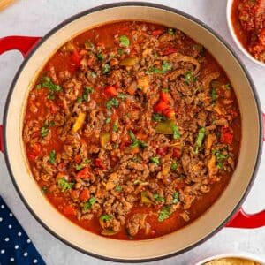 A red pot filled with Carne Picada.