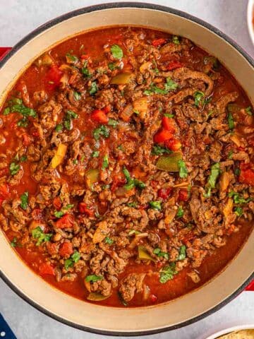 A red pot filled with Carne Picada.