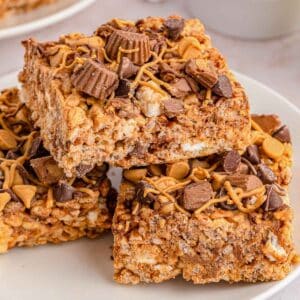 A stack of peanut butter rice krispie treats on a white plate.