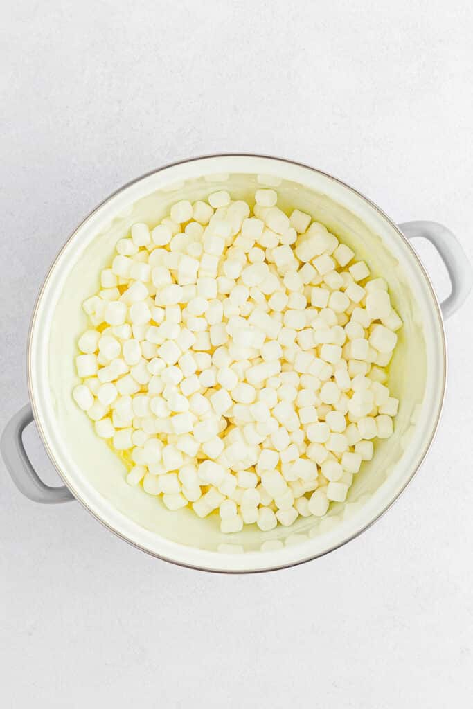 A large white pot filled with mini marshmallows.