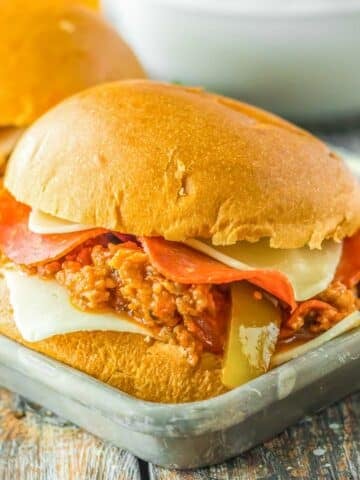 Two pizza sloppy joe sliders on a metal tray.