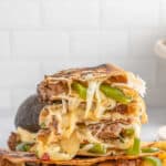 A stack of steak quesadillas on a cutting board.