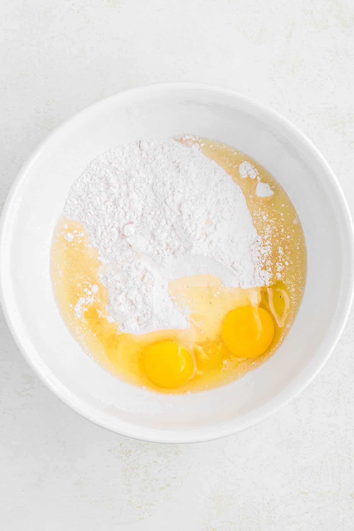 Small bowl of eggs, cake mix and vegetable oil.