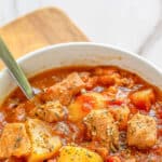 Quick and easy pork stew in a white bowl.