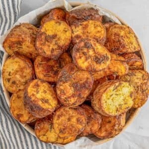 A bowl full of golden-brown, crispy air fryer potatoes.