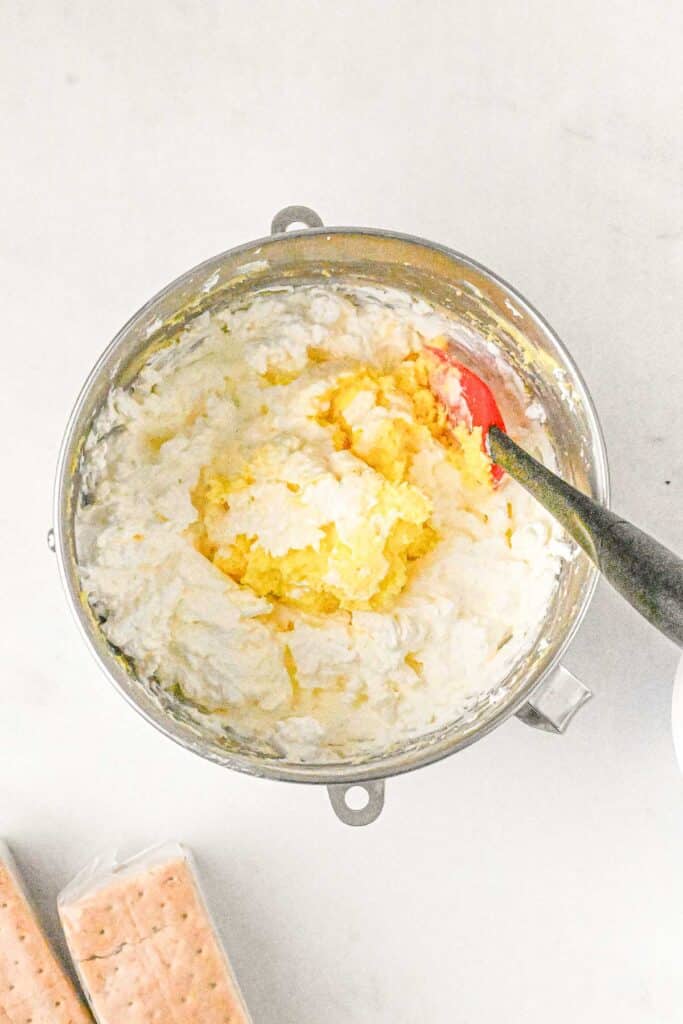 A top-down view of the filling ingredients being mixed together in a silver pot.