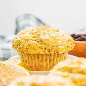 A lemon poppyseed muffin on a white plate.