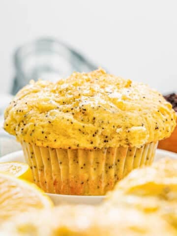 A lemon poppyseed muffin on a white plate.