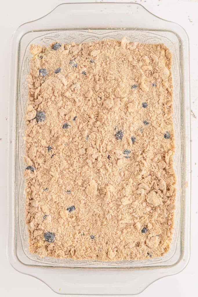 A baking dish filled with a Blueberry buckle mix ready to bake.