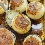 Baked onions in a baking dish, topped with a caramelized seasoning with a balsamic and butter sauce.