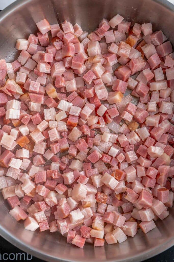 Chopped bacon bits in a cooking pan.