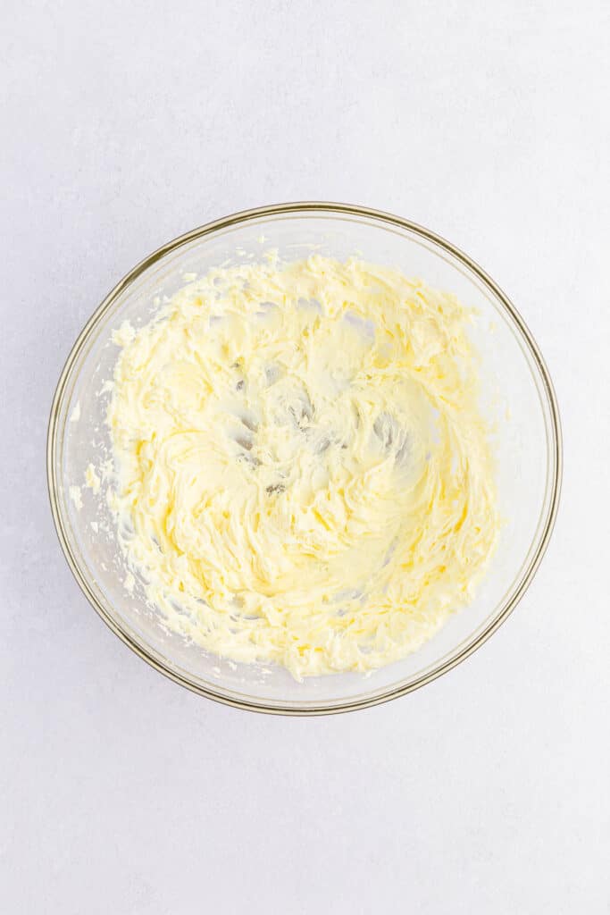 A large clear glass bowl with the lemon fluff mixture whipped together.