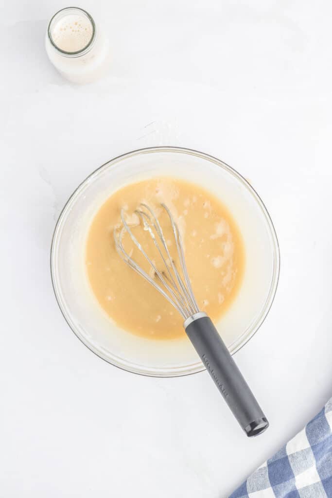 All glaze ingredients mixed together in a glass mixing bowl.
