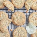 Potato chip cookies cooling on a wire rack with a few potato chips scattered between.