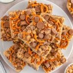 A white plate with several chocolate krispie treats stacked on each other.
