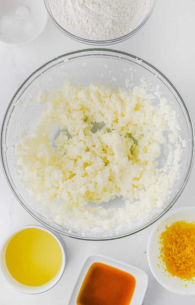 A clear glass bowl with creamed butter and sugar.