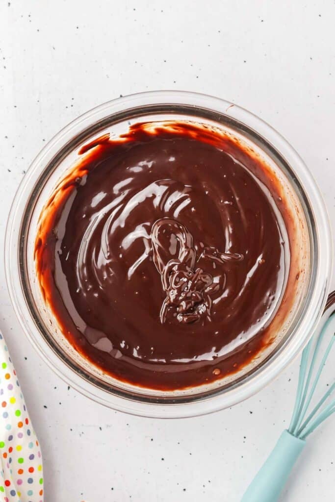 A glass bowl filled with smooth, chocolate ganache.