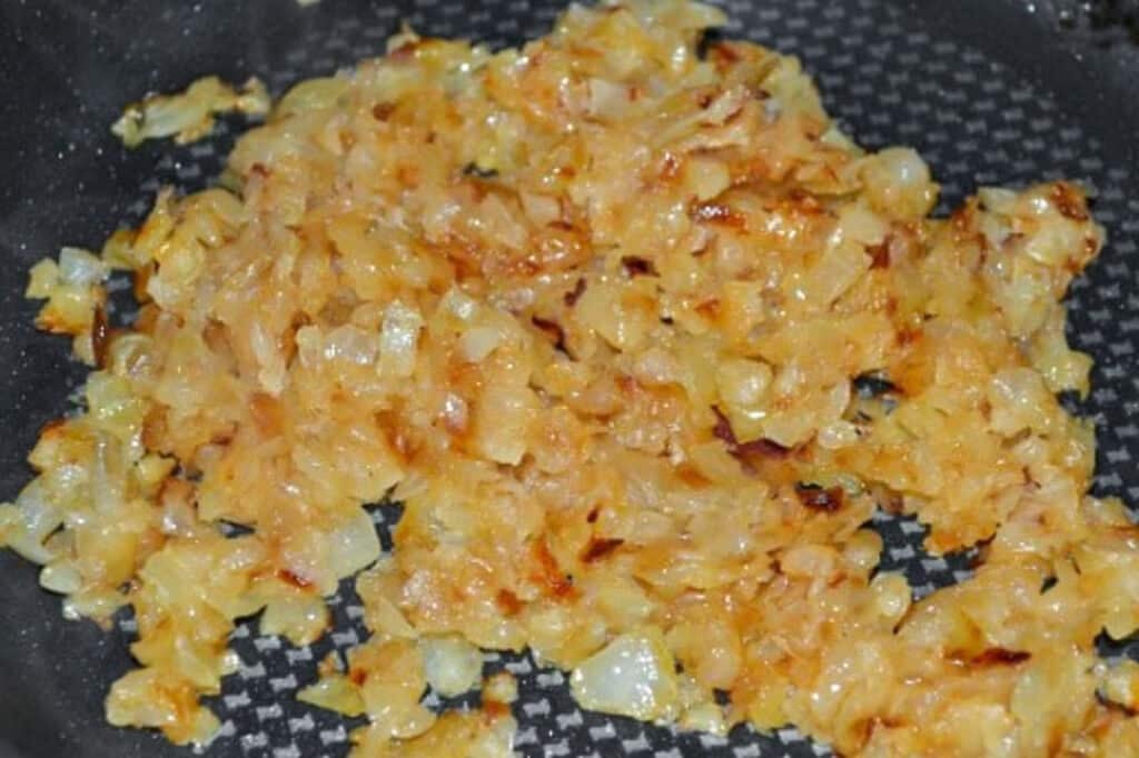 Finely chopped onions sautéed in a frying pan until golden brown.