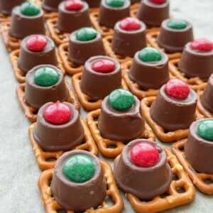 Rows of pretzels topped with m&ms and rolos.