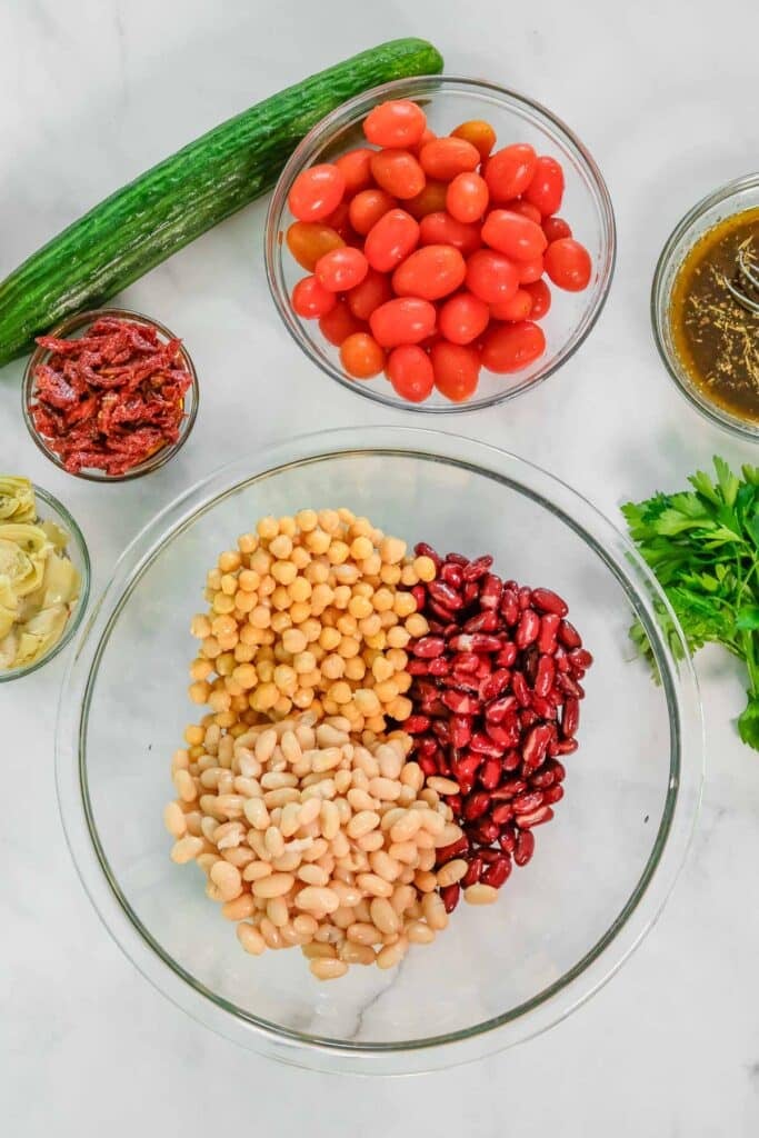 Three types of beans in a large clear bowl.